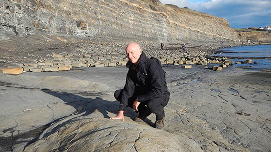 Picture of Richard Hallett, CGG Wellsite services on a beach 